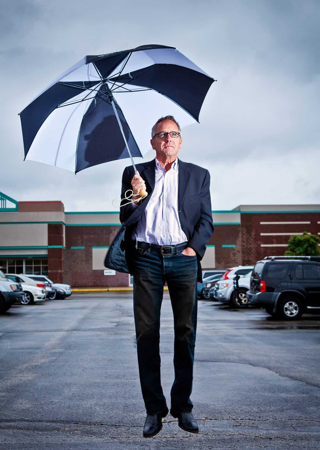 CEO of Switch umbrella portrait man jumping with umbrella