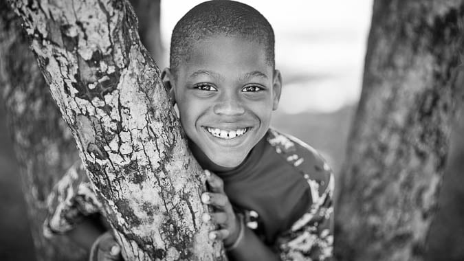 young boy smiling in black and white
