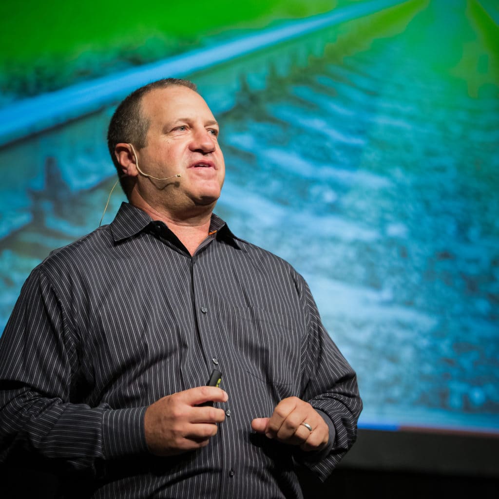 Man on stage speaking