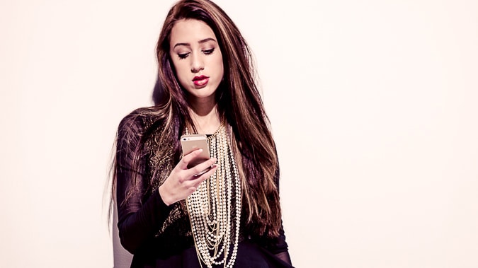 black and white photo of young woman with smartphone
