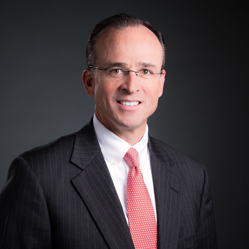 portrait of banker man in suit and glasses