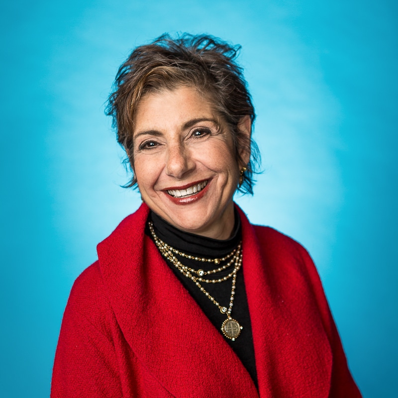 woman smiling in red woman in red with blue background