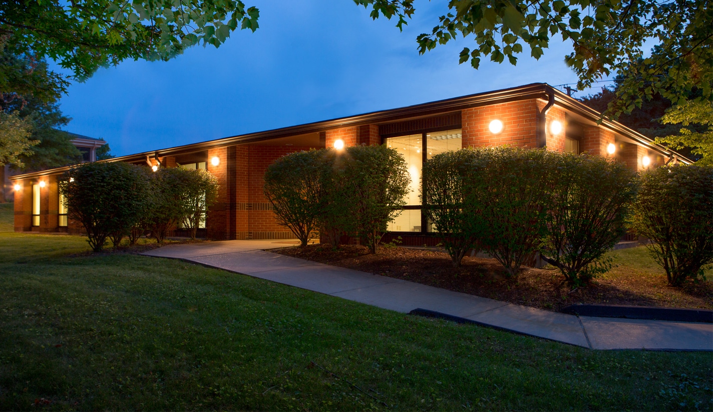1115 Olivette Executive Parkway building at dusk suburban office park building at dusk