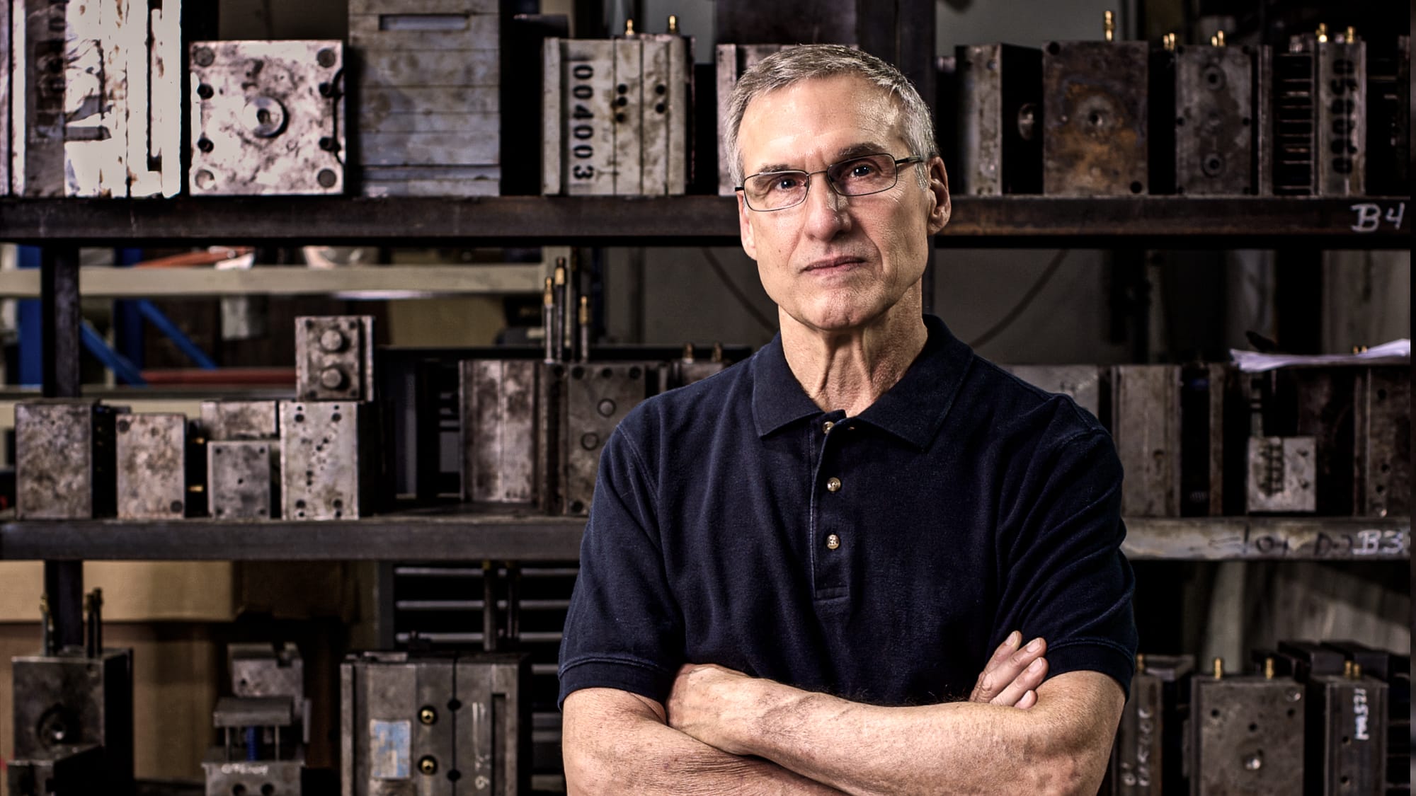 Man in warehouse with arms folded
