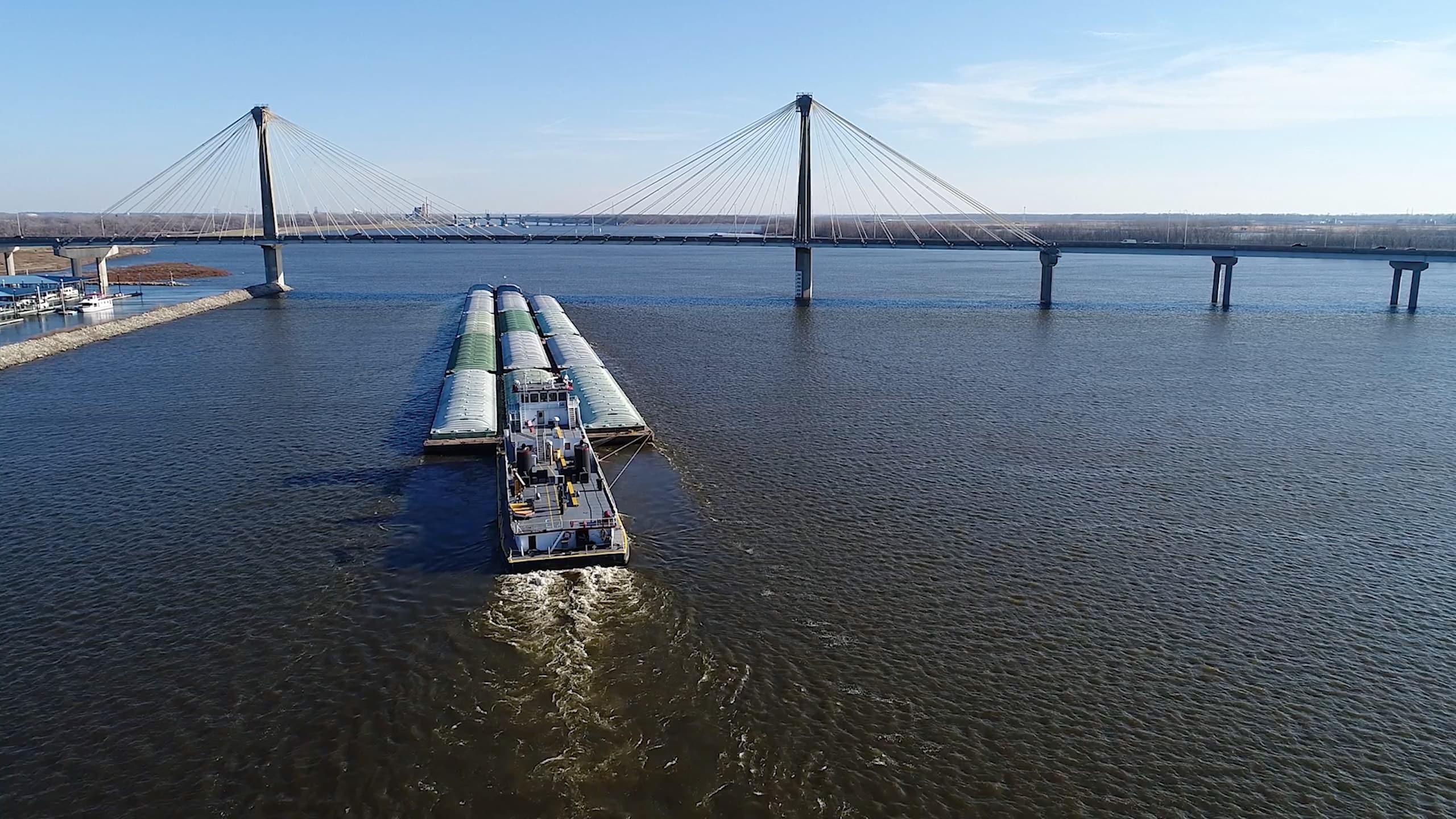 Aerial of barge in river near bridge